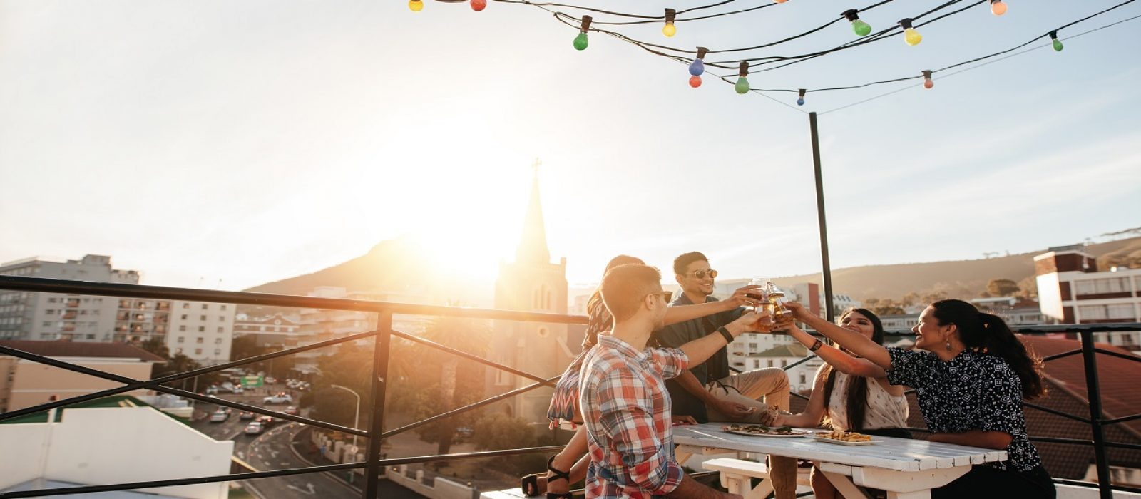 Outdoor,Shot,Of,Young,People,Toasting,Drinks,At,A,Rooftop